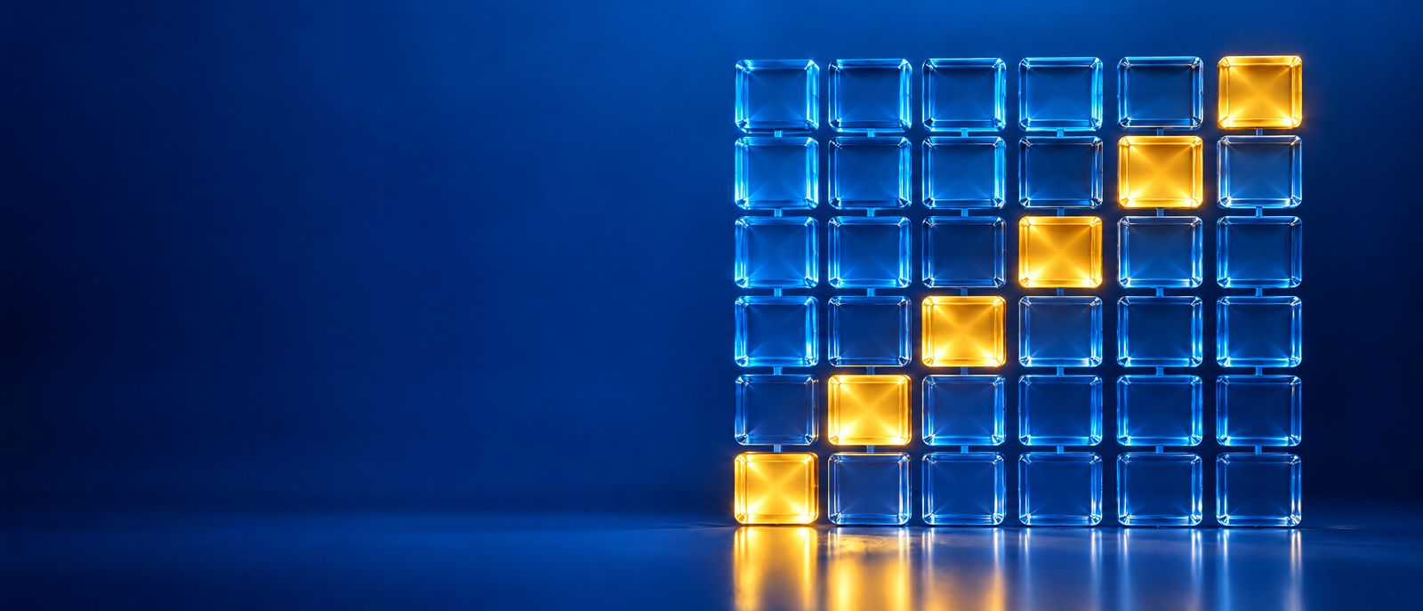 Cuadrícula de cubos de vidrio azul, como las casillas de un calendario, con algunos cubos iluminados en dorado